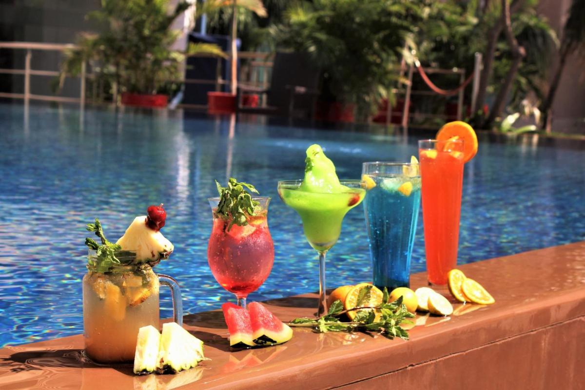 a group of drinks on a table next to a pool at Crowne Plaza Ahmedabad City Centre by IHG in Ahmedabad
