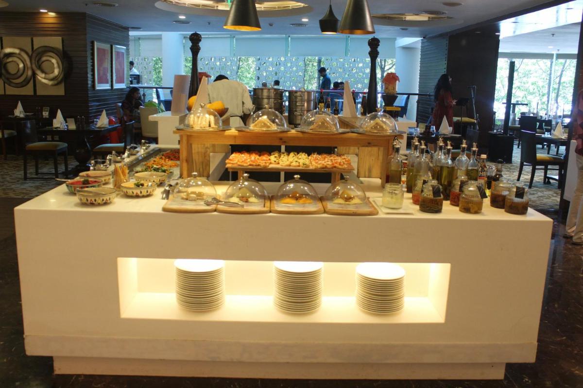a buffet of food on a table in a restaurant at Crowne Plaza Ahmedabad City Centre by IHG in Ahmedabad