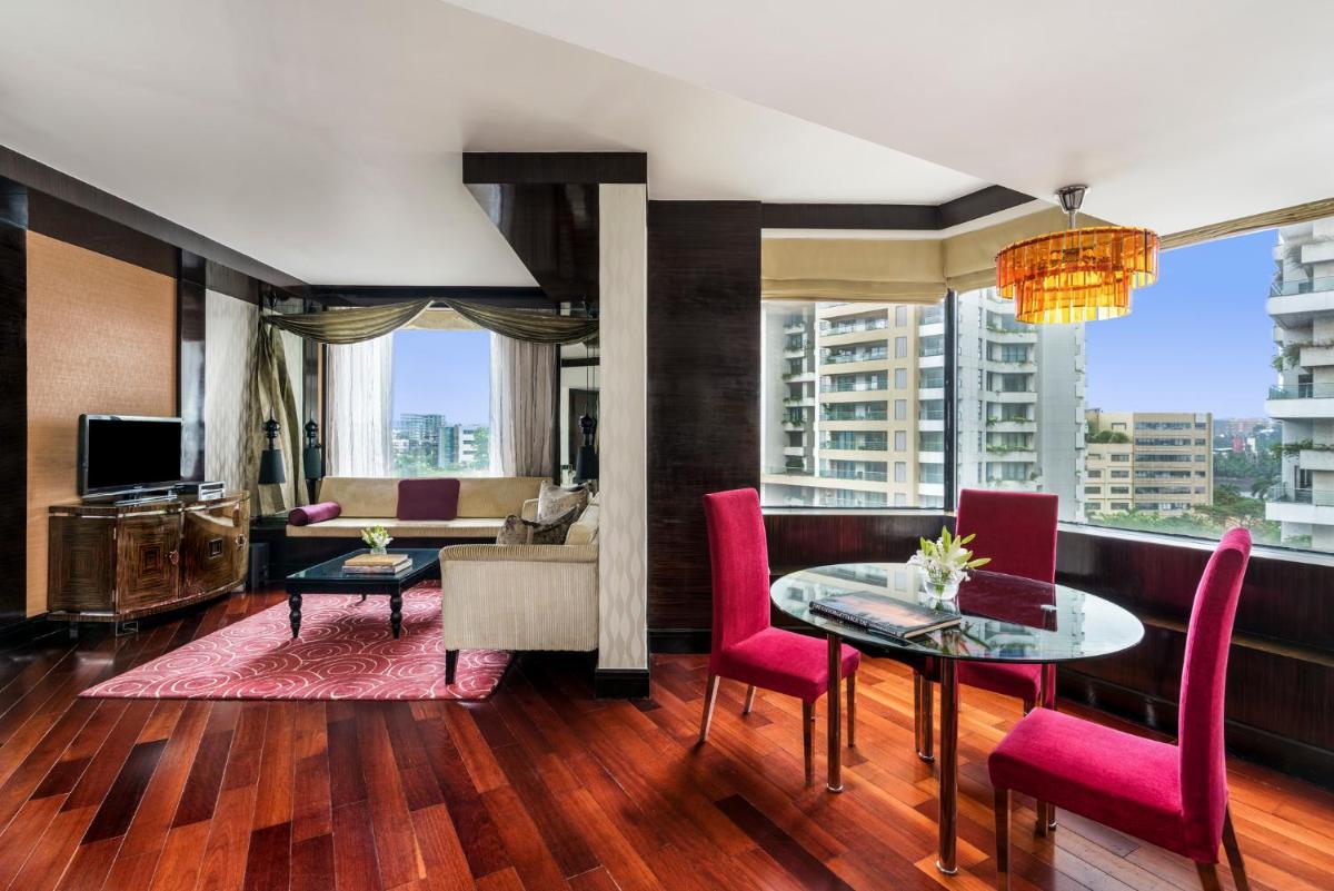 a living room with a table and chairs and a couch at Sofitel Mumbai BKC in Mumbai