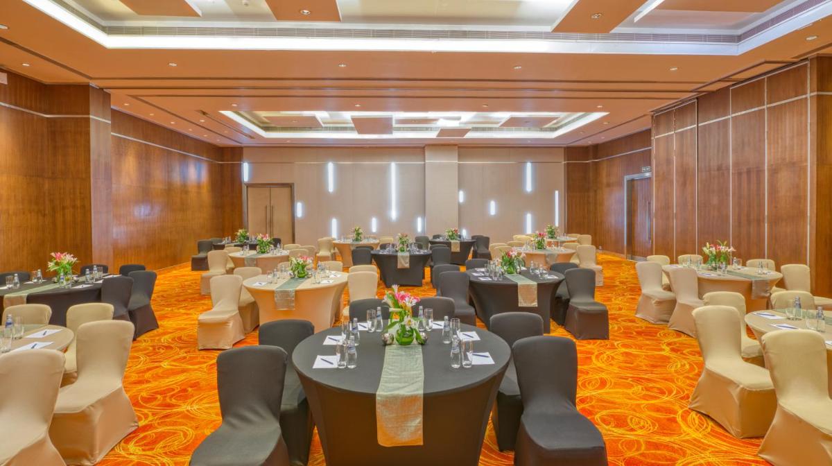 a large banquet hall with tables and chairs at Novotel Bengaluru Outer Ring Road in Bengaluru
