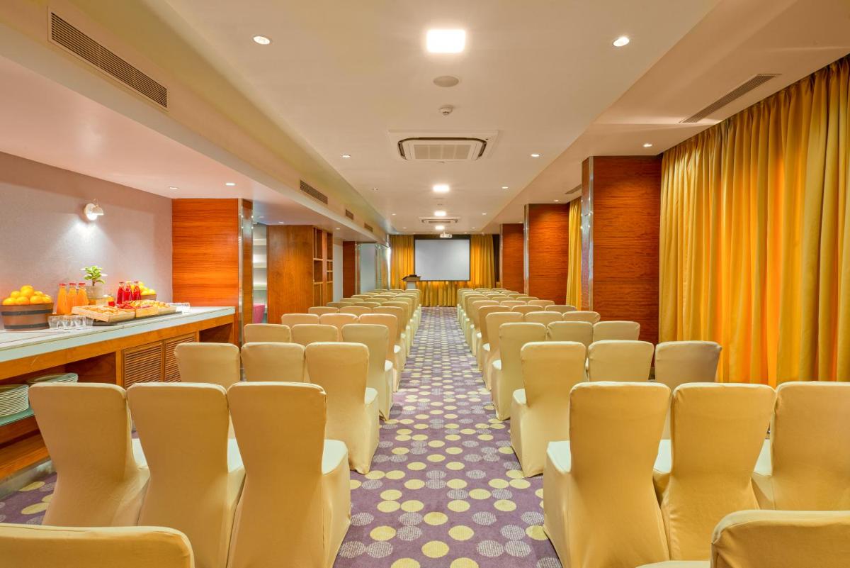 a row of chairs in a conference room at Novotel Bengaluru Outer Ring Road in Bengaluru
