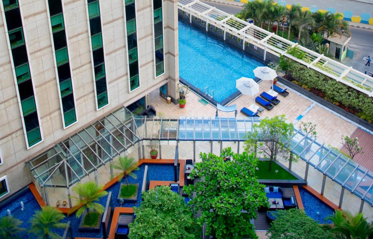 an overhead view of a building with a swimming pool at Novotel Bengaluru Outer Ring Road in Bengaluru