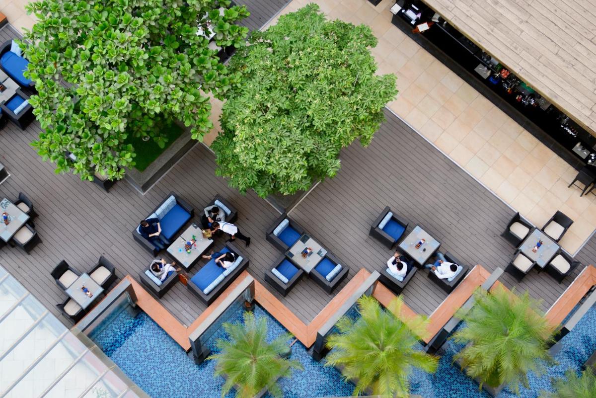 an overhead view of a restaurant with tables and chairs at Novotel Bengaluru Outer Ring Road in Bengaluru
