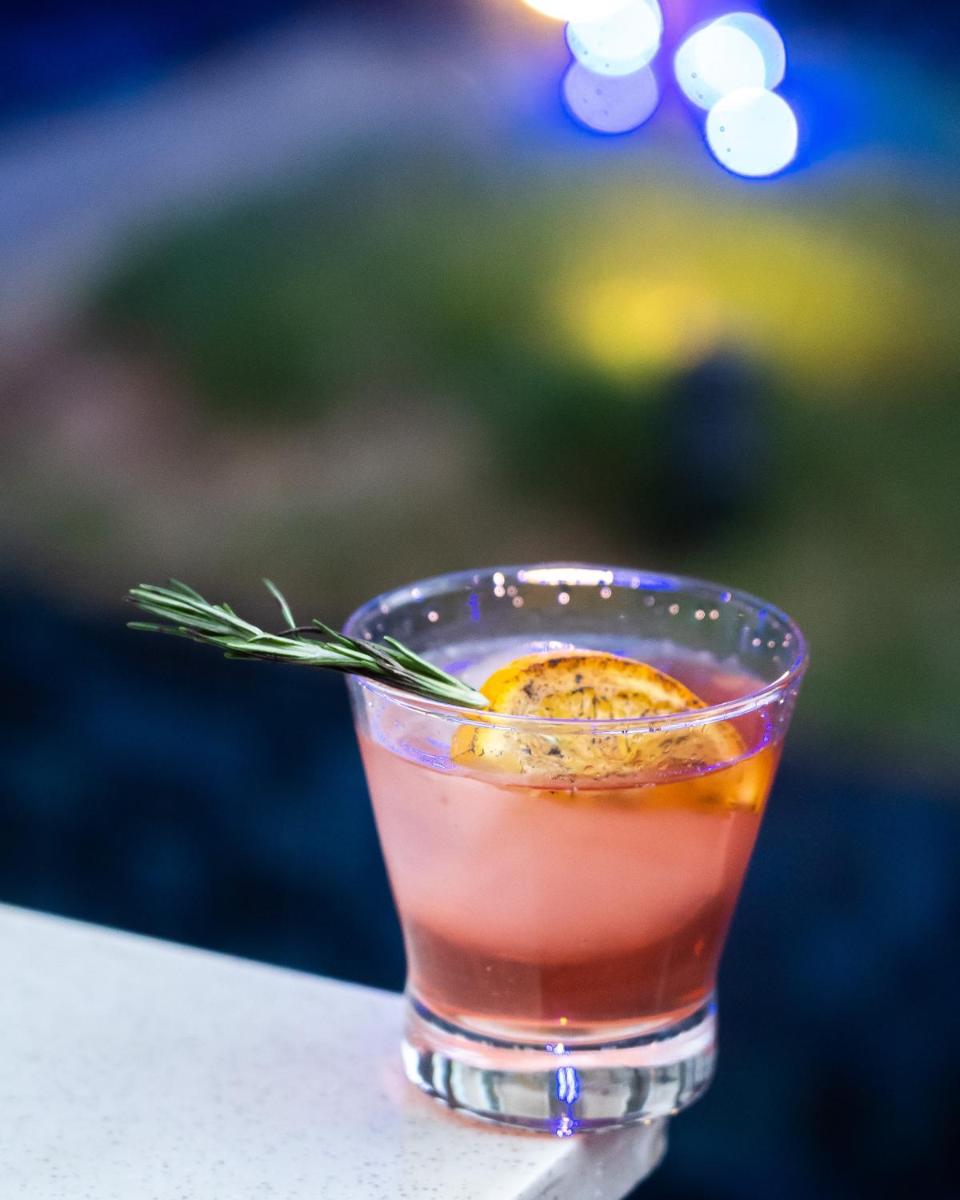 a drink in a glass sitting on a table at Novotel Bengaluru Outer Ring Road in Bengaluru