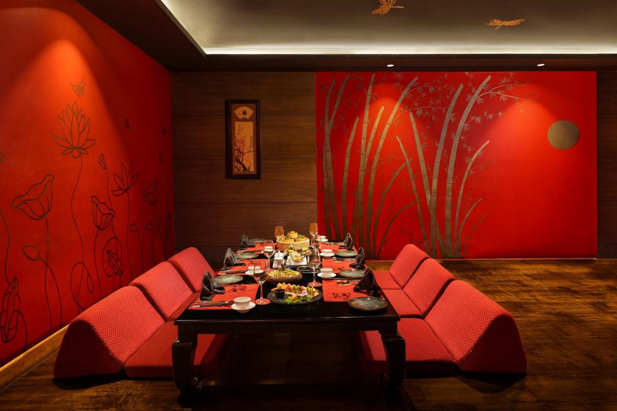 a dining room with a table with food on it at Radisson Jaipur City Center in Jaipur