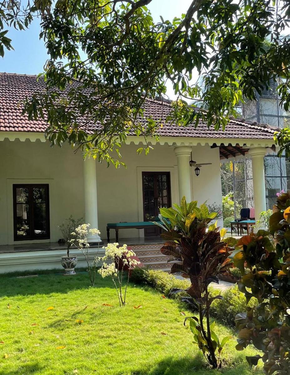 a house with a green yard in front of it at The Postcard Cuelim, Goa in Cansaulim