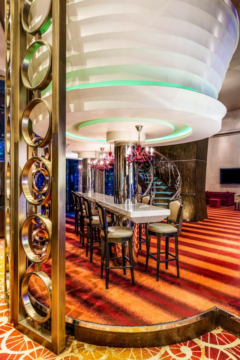 a dining room with a long table and chairs at Sofitel Mumbai BKC in Mumbai
