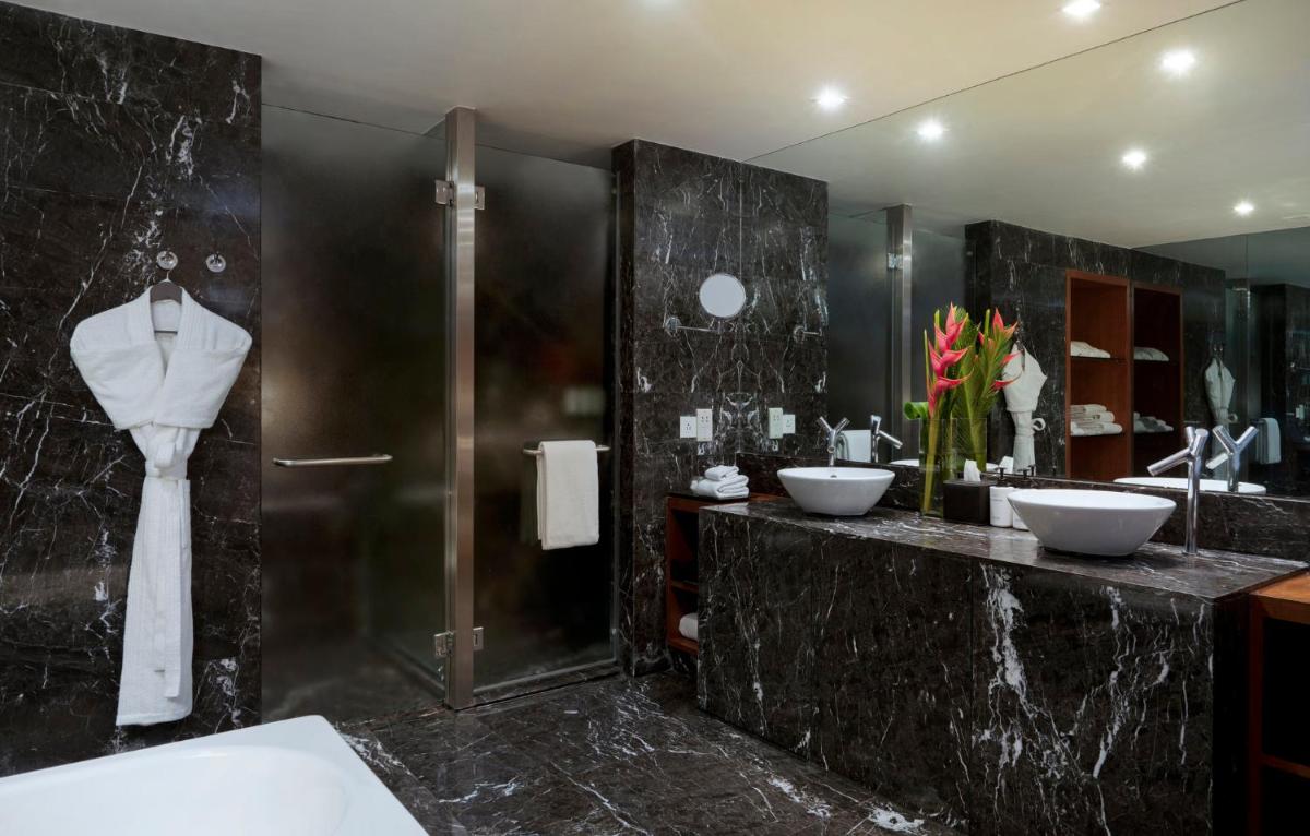 a bathroom with two sinks and a shower at InterContinental Marine Drive Mumbai by IHG in Mumbai