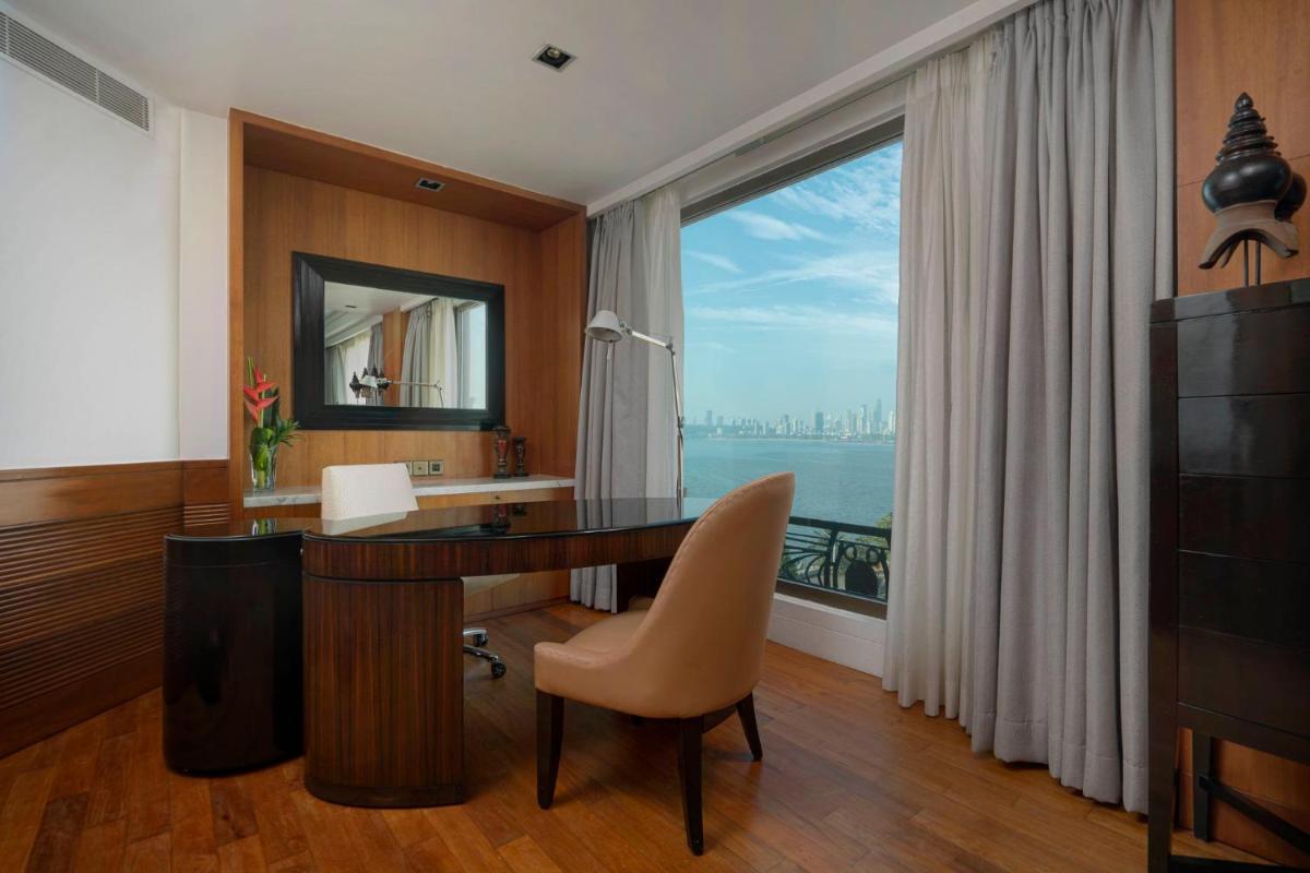 a room with a desk and a large window at InterContinental Marine Drive Mumbai by IHG in Mumbai