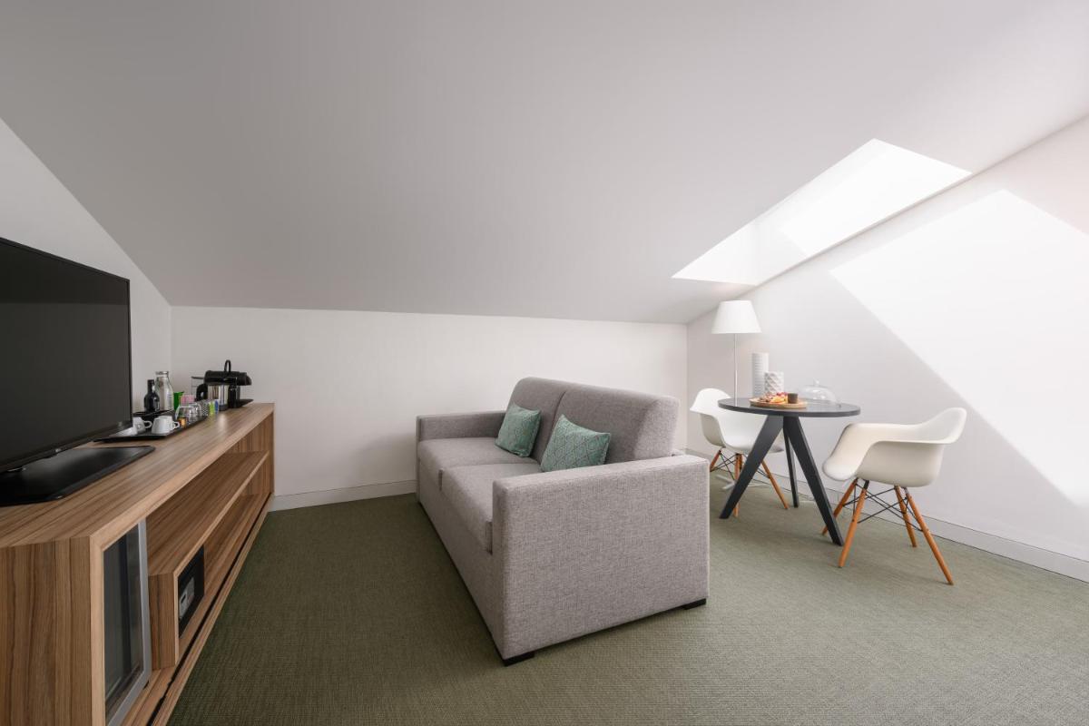 Uma televisão e/ou sistema de entretenimento em Inspira Liberdade Boutique Hotel