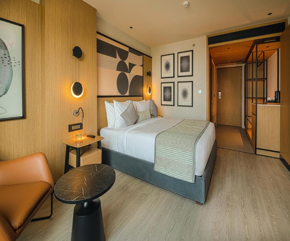 a hotel room with a bed and a chair at Parallel Hotel Udaipur, a member of Radisson Individuals in Udaipur