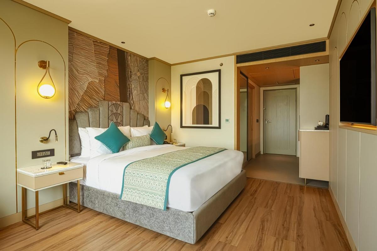 a bedroom with a large bed and a television at Parallel Hotel Udaipur, a member of Radisson Individuals in Udaipur