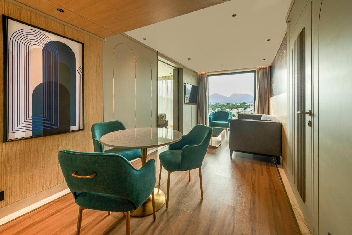 a room with a table and chairs and a window at Parallel Hotel Udaipur, a member of Radisson Individuals in Udaipur