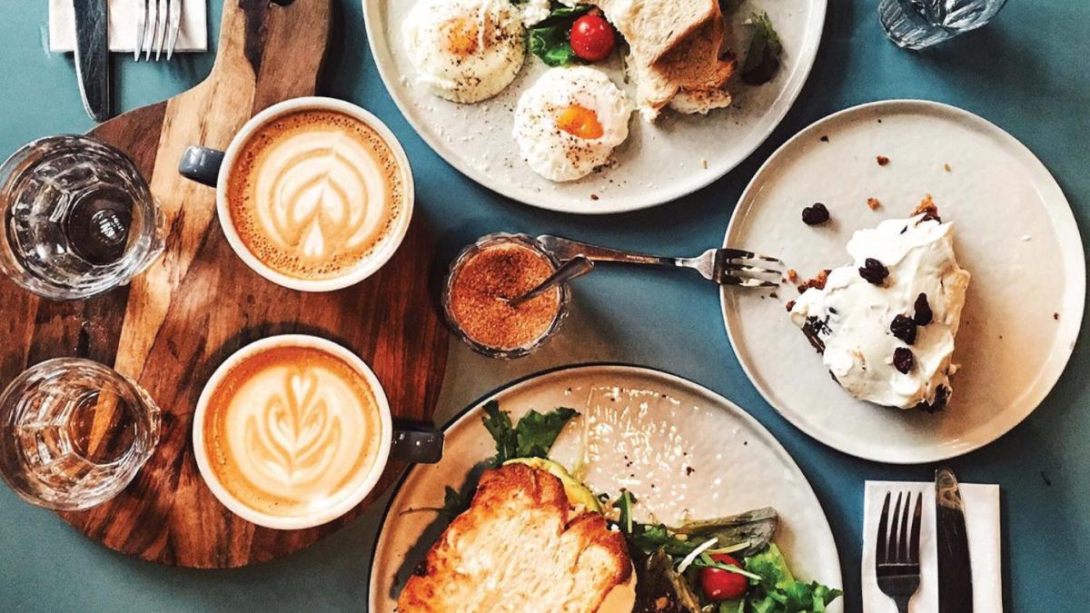 a table topped with plates of food and cups of coffee at Holiday Inn New Delhi Mayur Vihar Noida by IHG in New Delhi a table topped with plates of food and cups of coffee at Holiday Inn New Delhi Mayur Vihar Noida by IHG in New Delhi