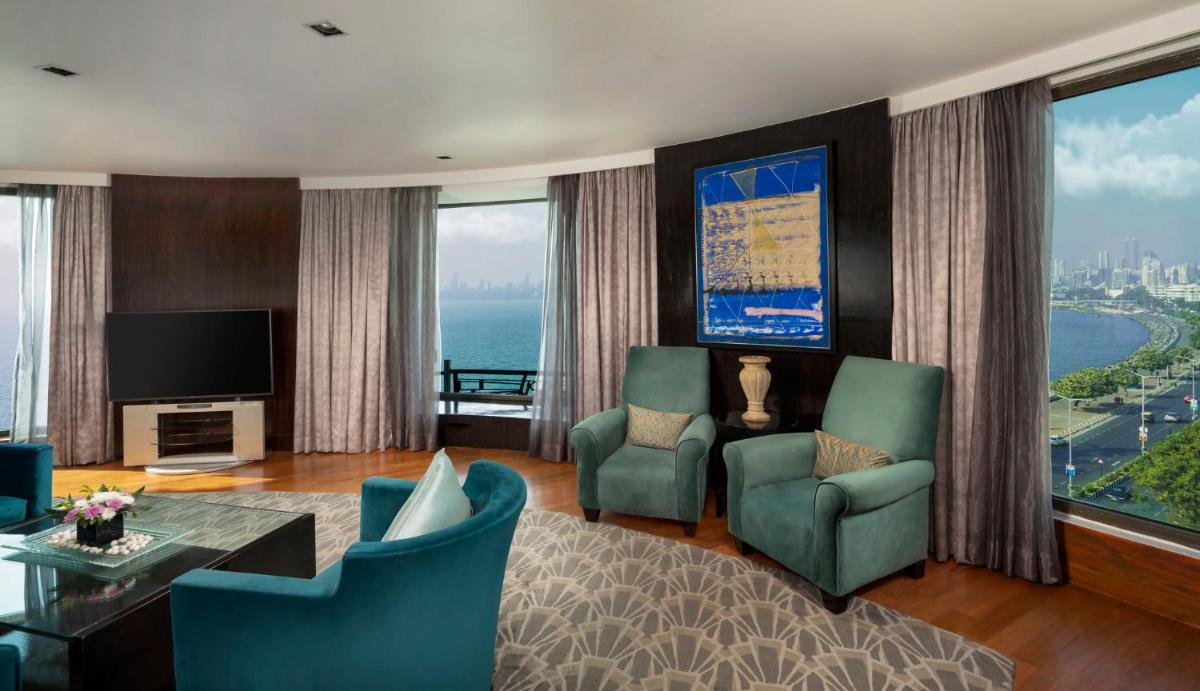 a living room with a view of the ocean at InterContinental Marine Drive Mumbai by IHG in Mumbai