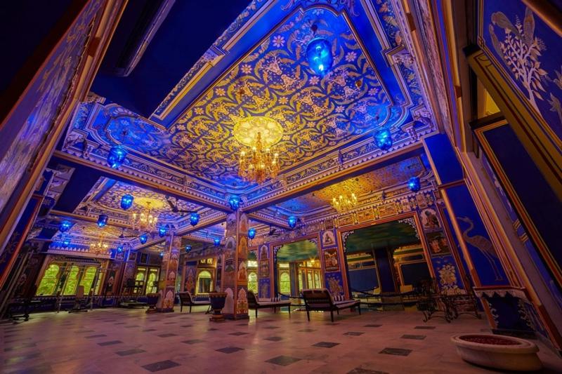 a large room with a ceiling with blue lights at Chunda Palace in Udaipur