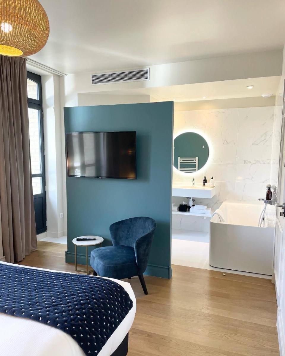 Un ou plusieurs lits dans un hébergement de l'établissement L'INVITATION AU VOYAGE - Hôtel & Spa