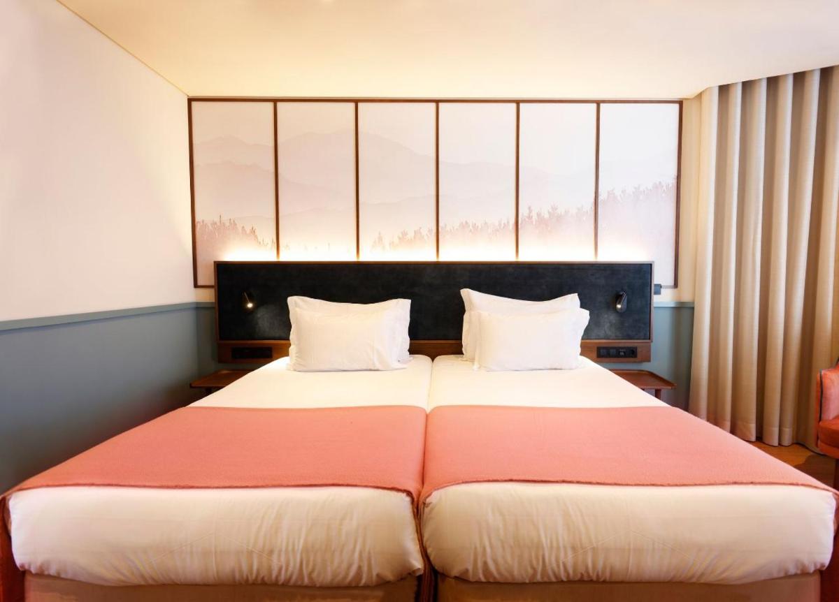 Uma cama ou camas num quarto em Montebelo Viseu Congress Hotel & Spa