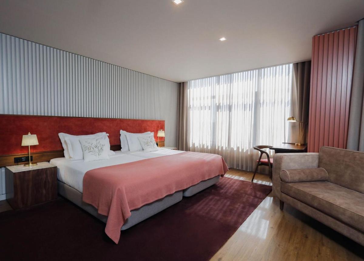 Uma cama ou camas num quarto em Montebelo Viseu Congress Hotel & Spa