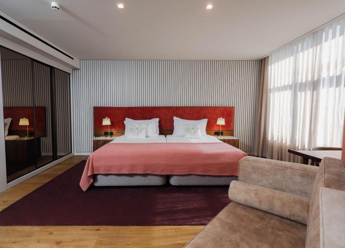 Uma cama ou camas num quarto em Montebelo Viseu Congress Hotel & Spa