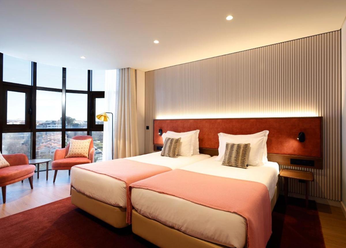 Uma cama ou camas num quarto em Montebelo Viseu Congress Hotel & Spa