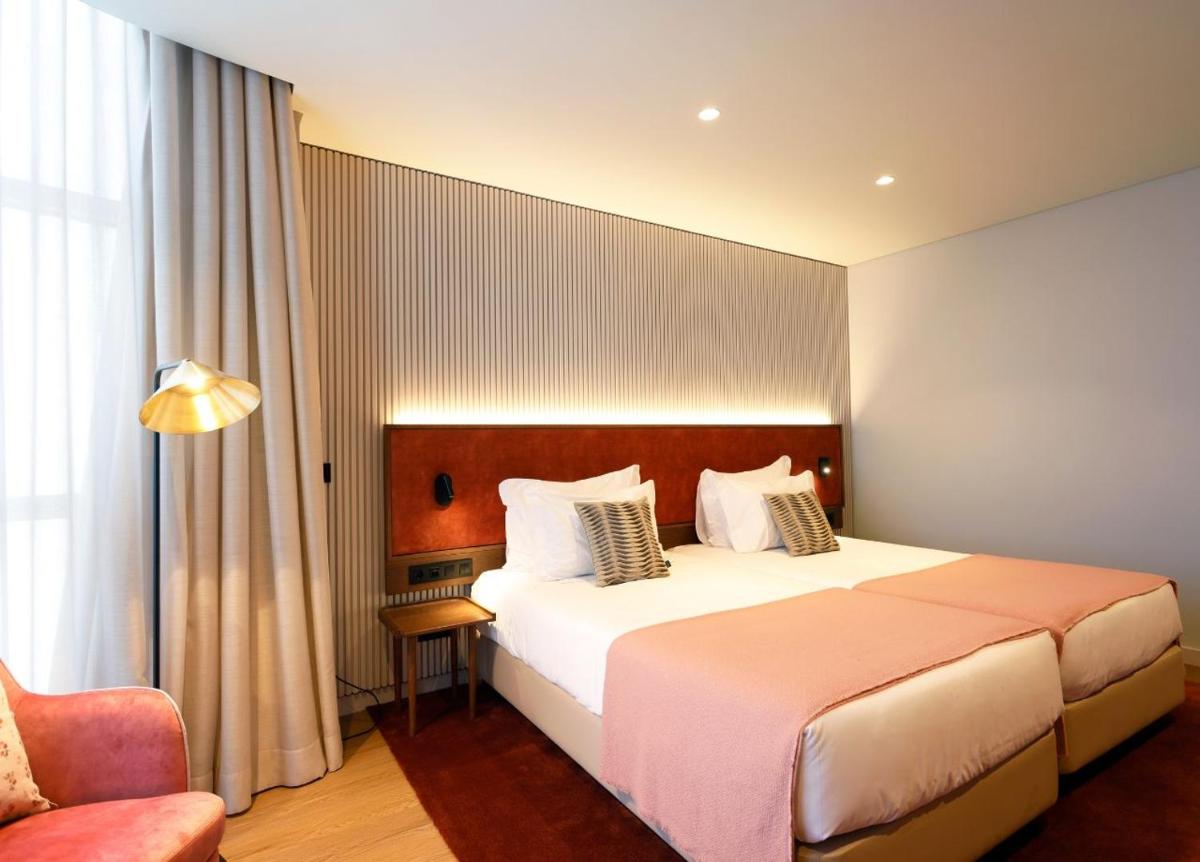 Uma cama ou camas num quarto em Montebelo Viseu Congress Hotel & Spa