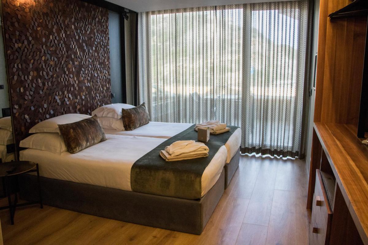 Uma cama ou camas num quarto em Well Hotel & Spa