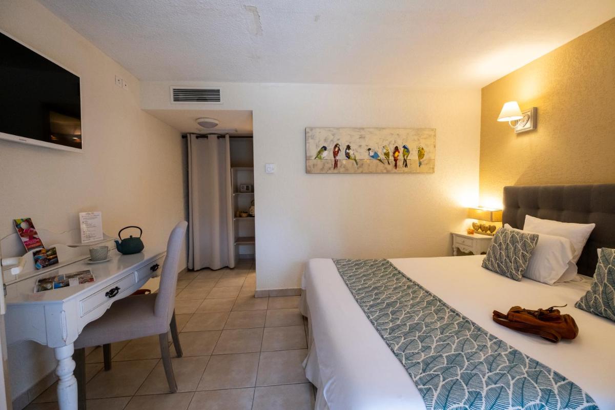 Un ou plusieurs lits dans un hébergement de l'établissement Le Belvédère Hotel et Bien être