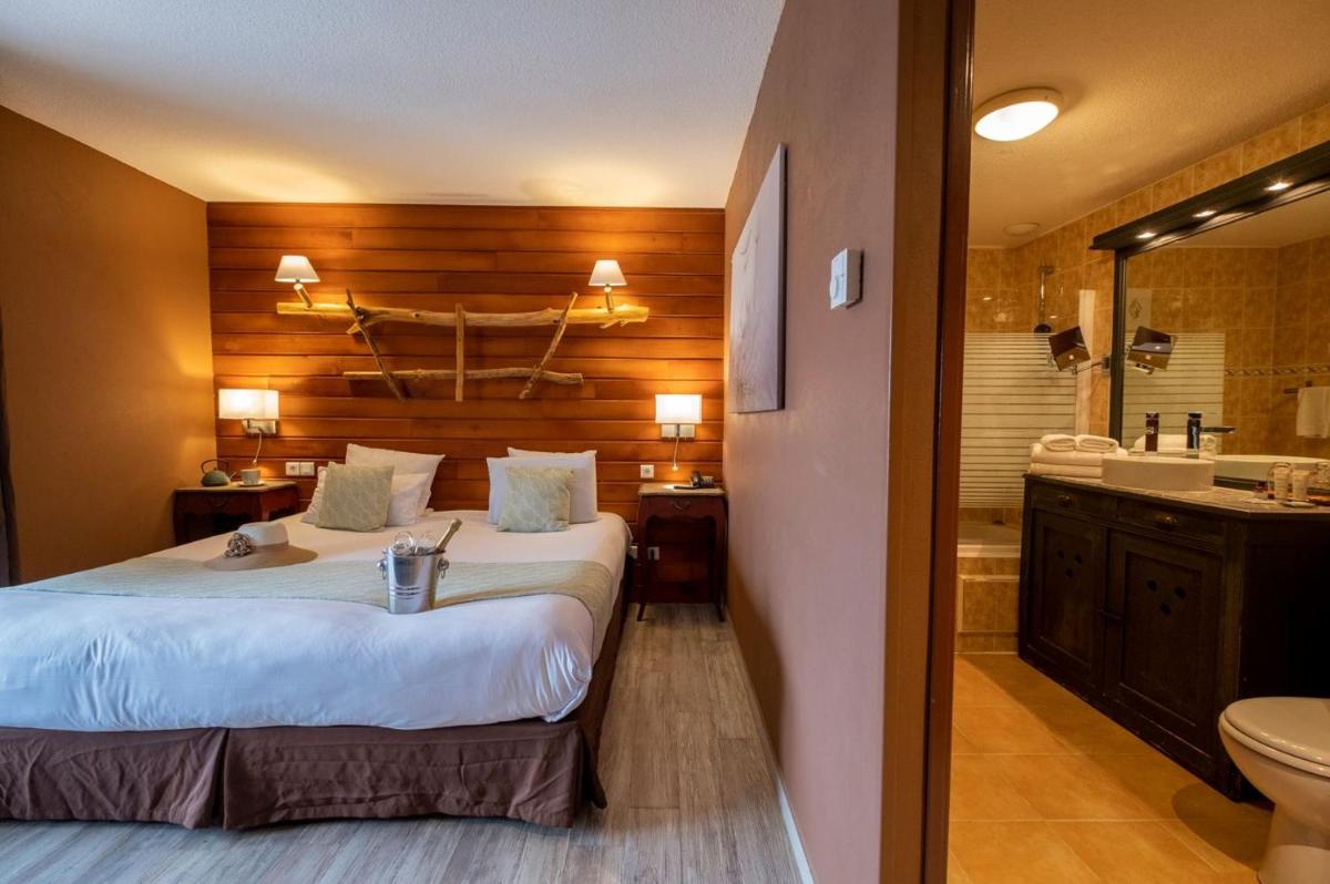 Un ou plusieurs lits dans un hébergement de l'établissement Le Belvédère Hotel et Bien être