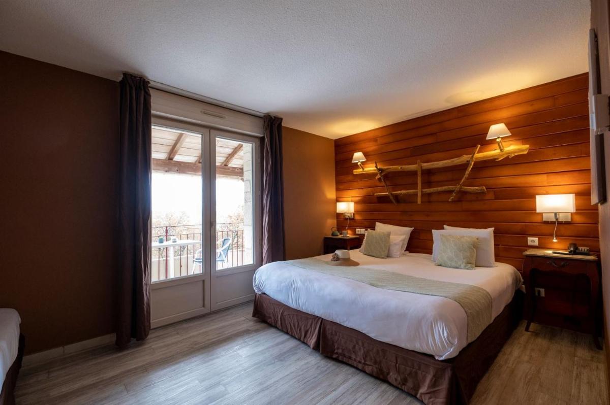 Un ou plusieurs lits dans un hébergement de l'établissement Le Belvédère Hotel et Bien être