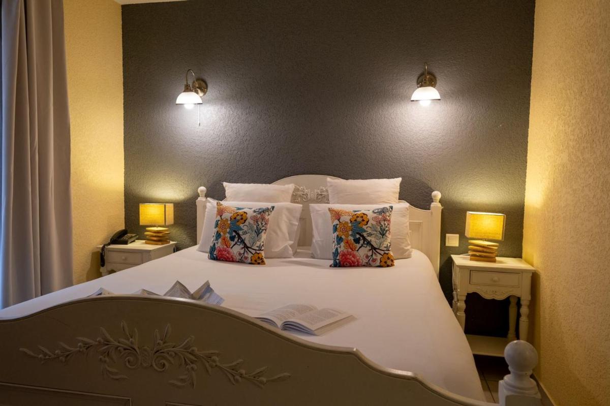 Un ou plusieurs lits dans un hébergement de l'établissement Le Belvédère Hotel et Bien être