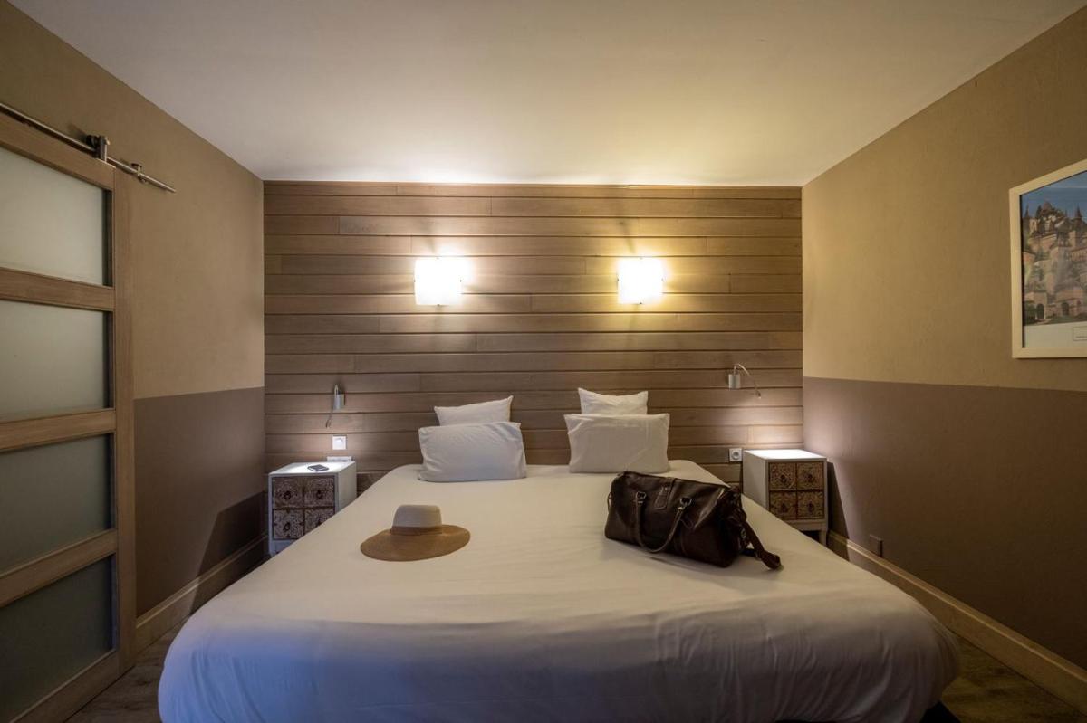Un ou plusieurs lits dans un hébergement de l'établissement Le Belvédère Hotel et Bien être