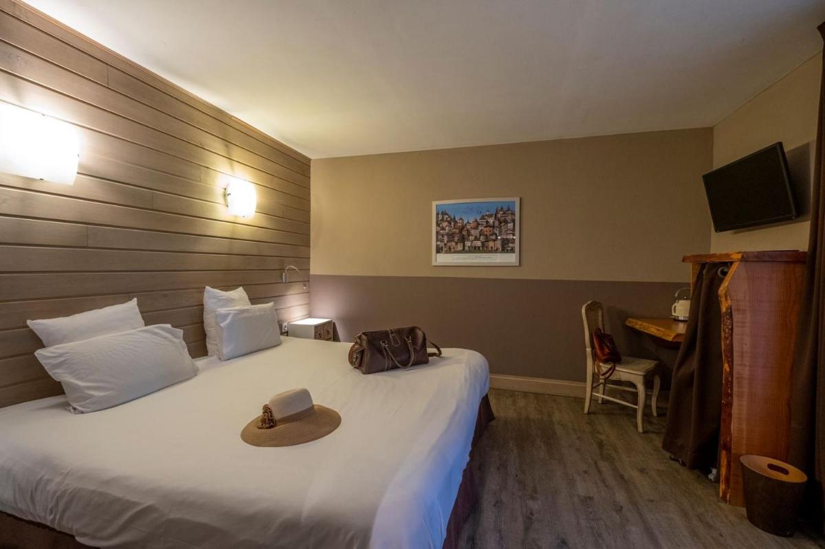 Un ou plusieurs lits dans un hébergement de l'établissement Le Belvédère Hotel et Bien être