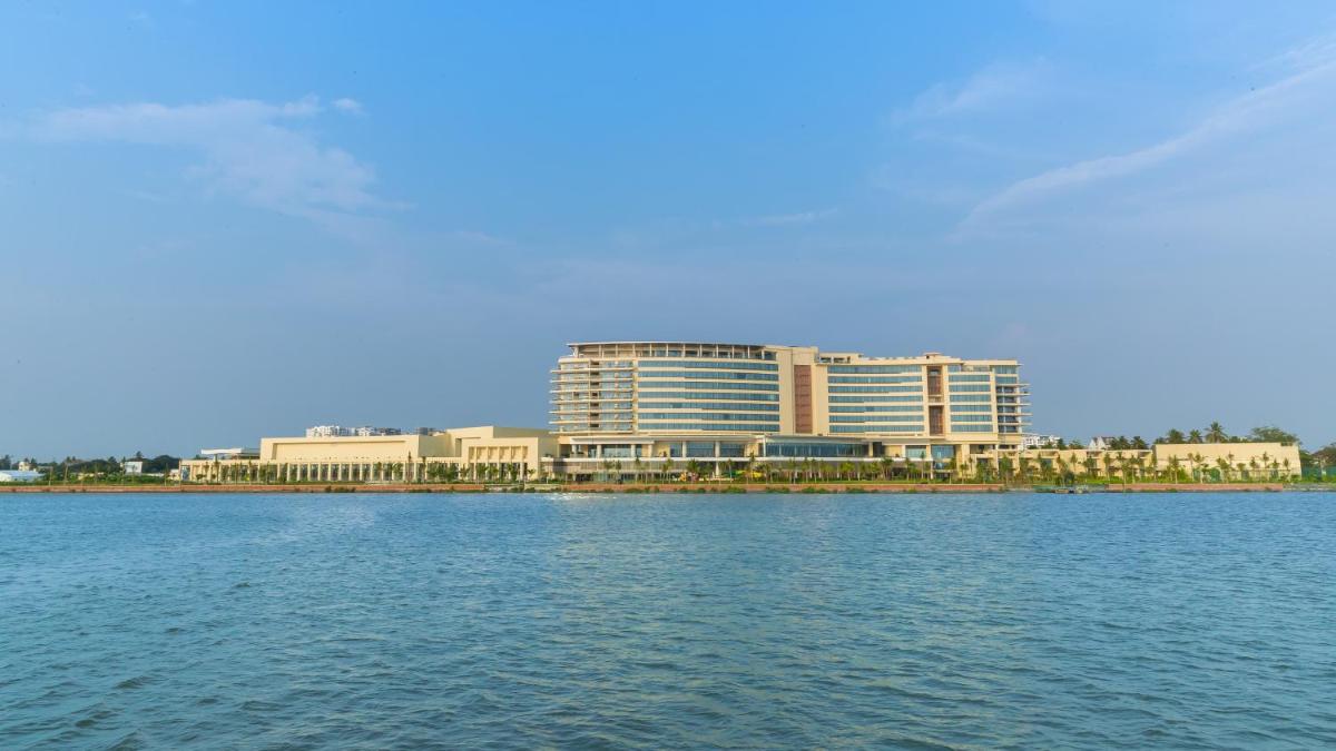 a large building sitting on top of a large body of water at Grand Hyatt Kochi Bolgatty in Cochin