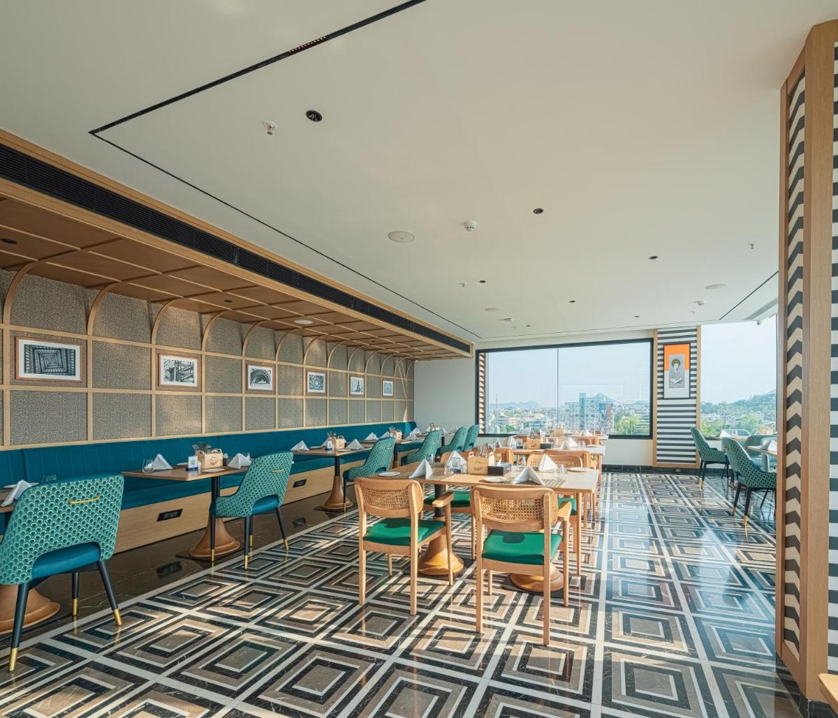 a rendering of a dining room with tables and chairs at Parallel Hotel Udaipur, a member of Radisson Individuals in Udaipur