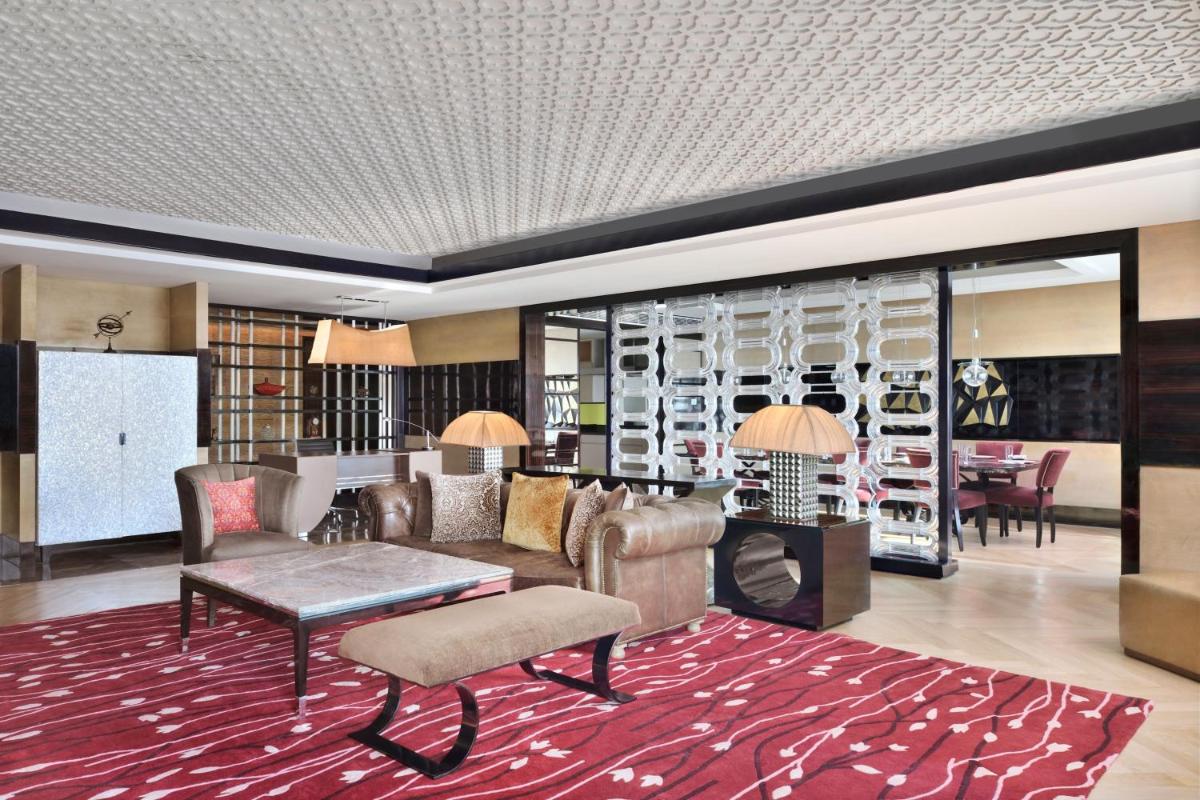a lobby with chairs and a table and a living room at JW Marriott Hotel New Delhi Aerocity in New Delhi a lobby with chairs and a table and a living room at JW Marriott Hotel New Delhi Aerocity in New Delhi
