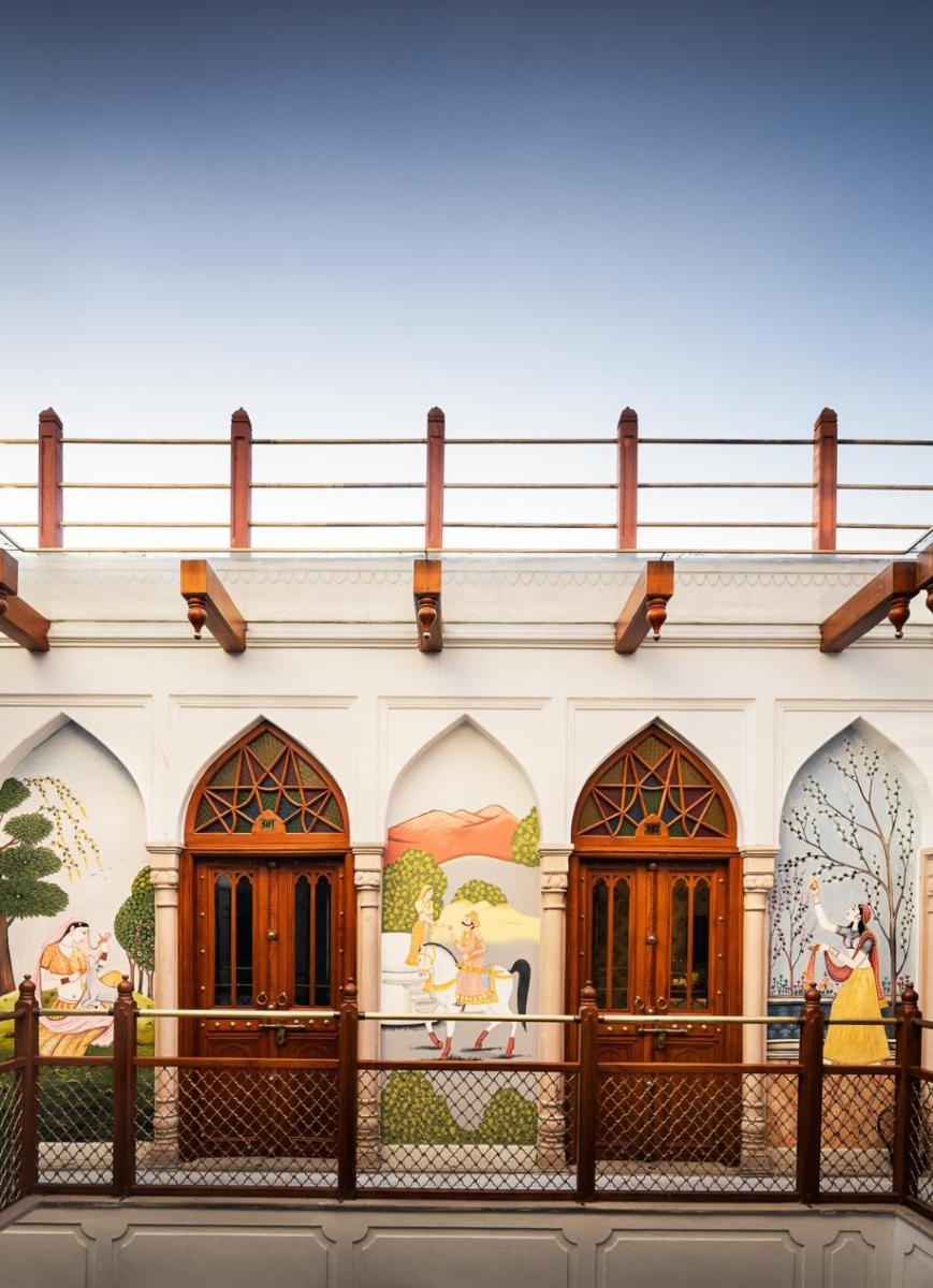 a building with paintings on the side of it at Haveli Dharampura & Golden Haveli- UNESCO awarded Boutique Heritage Hotel in New Delhi a building with paintings on the side of it at Haveli Dharampura & Golden Haveli- UNESCO awarded Boutique Heritage Hotel in New Delhi