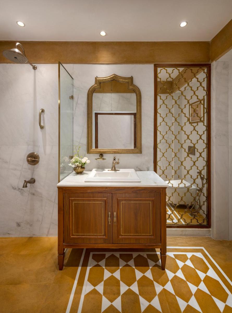 a bathroom with a sink and a mirror at Haveli Dharampura & Golden Haveli- UNESCO awarded Boutique Heritage Hotel in New Delhi a bathroom with a sink and a mirror at Haveli Dharampura & Golden Haveli- UNESCO awarded Boutique Heritage Hotel in New Delhi