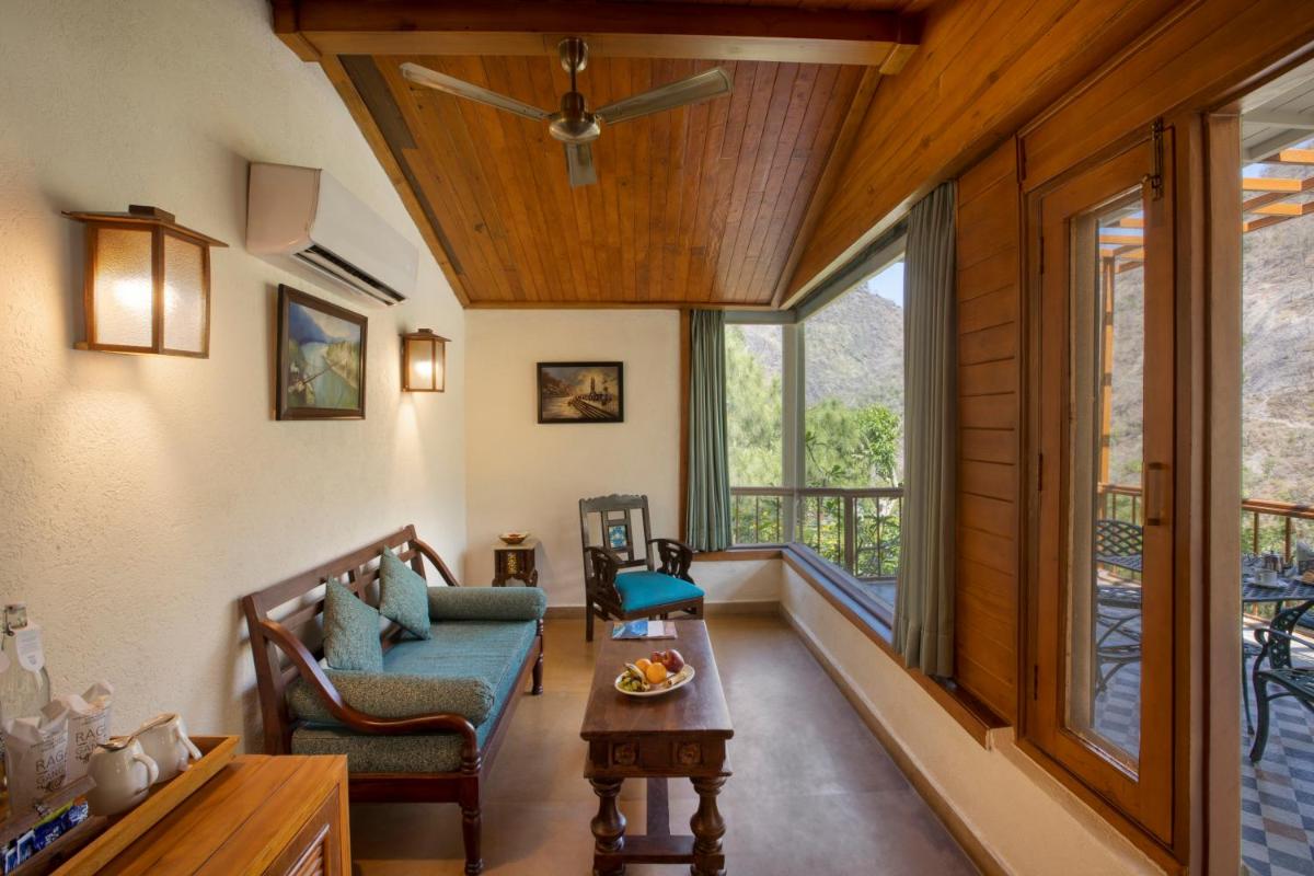 a living room with a couch and a table at Raga on the Ganges, Rishikesh in Rishīkesh