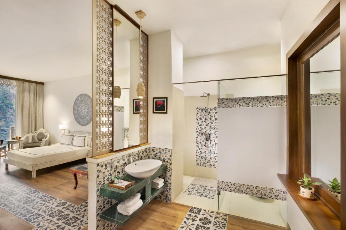 a bathroom with a shower and a sink and a mirror at Raga on the Ganges, Rishikesh in Rishīkesh