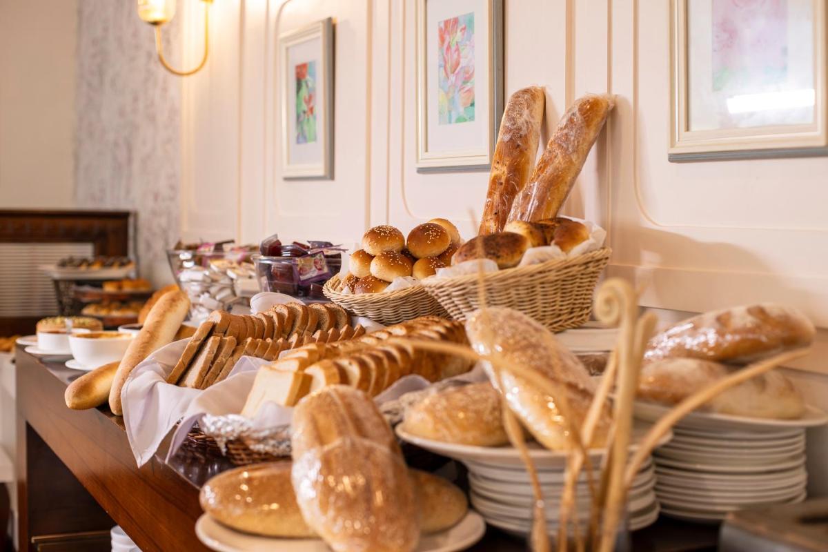 a table topped with baskets of bread and pastries at Raga on the Ganges, Rishikesh in Rishīkesh