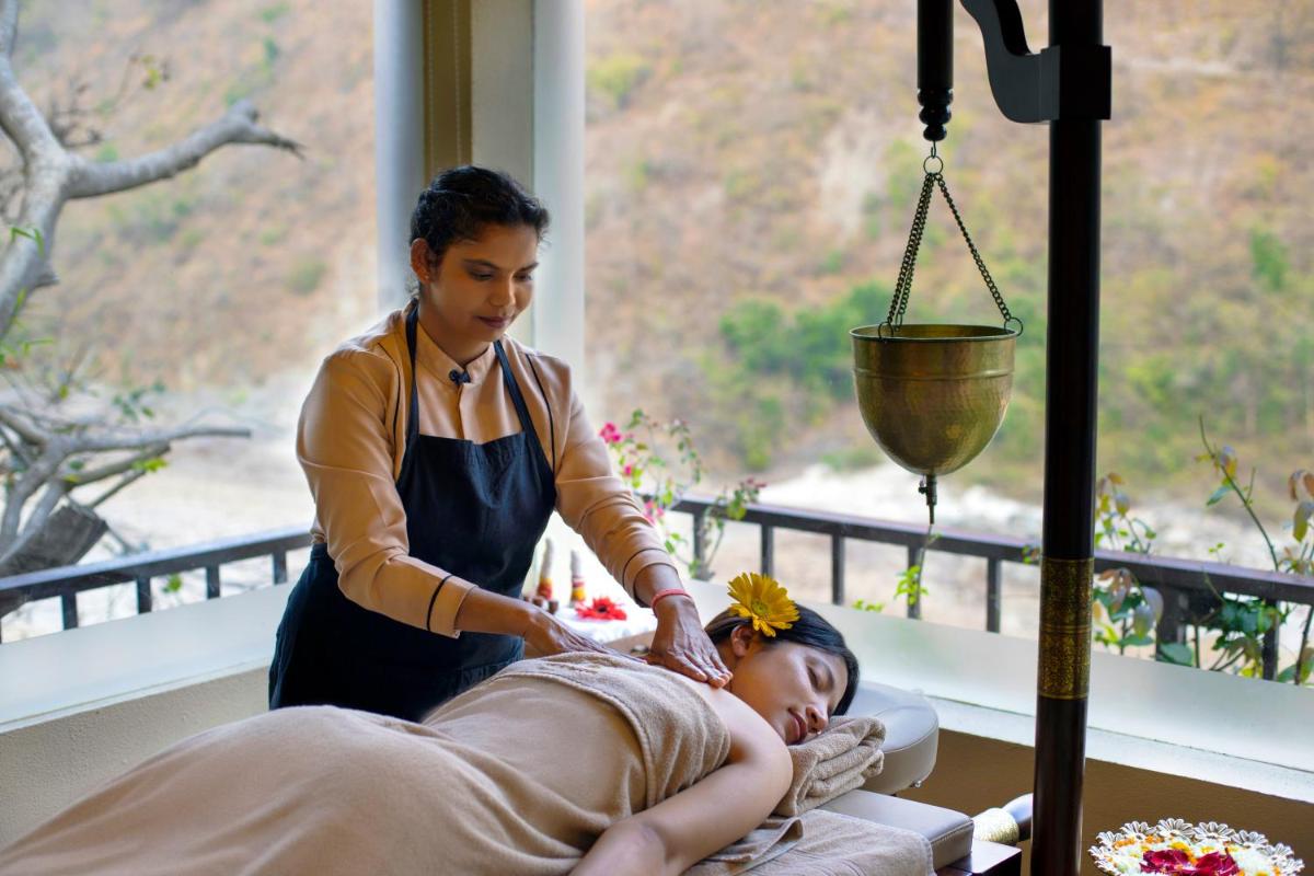 a woman is giving a woman a massage at Raga on the Ganges, Rishikesh in Rishīkesh