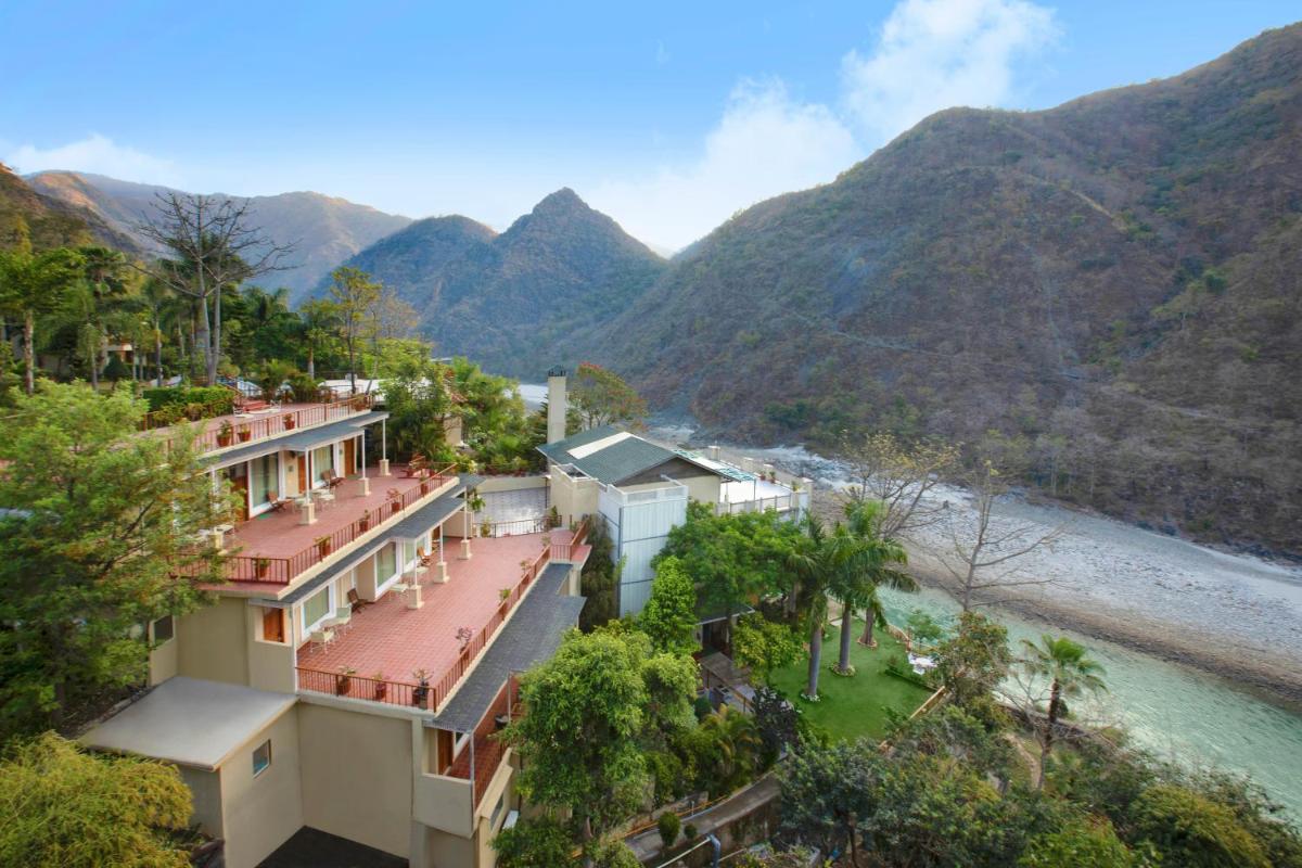an aerial view of a house with mountains in the background at Raga on the Ganges, Rishikesh in Rishīkesh