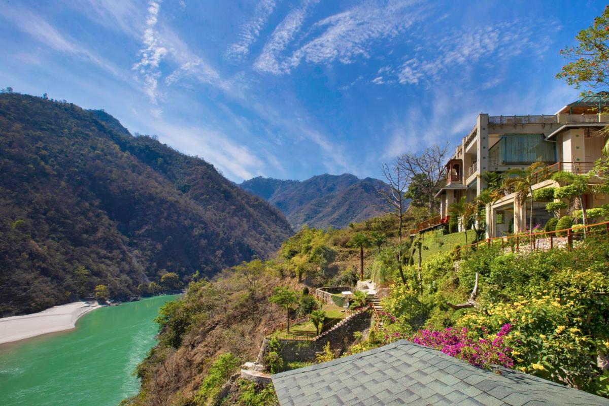 a house on the side of a hill next to a river at Raga on the Ganges, Rishikesh in Rishīkesh