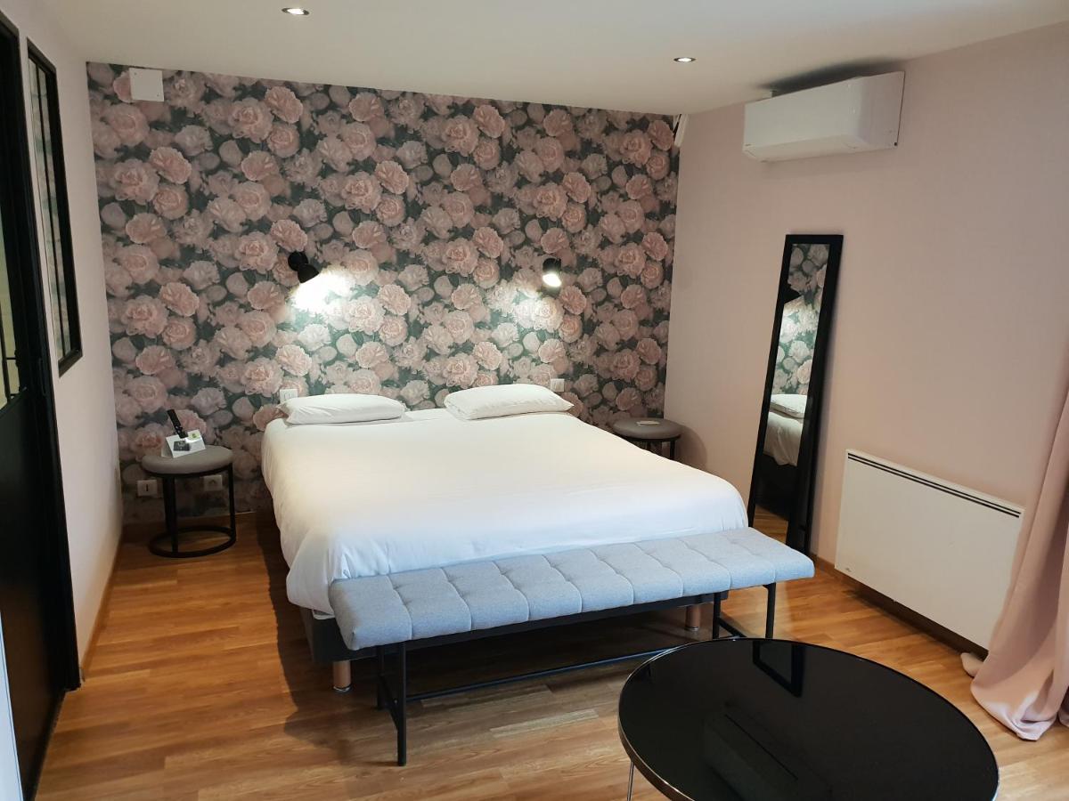 Un ou plusieurs lits dans un hébergement de l'établissement Logis Hôtel Restaurant Aux Maisons