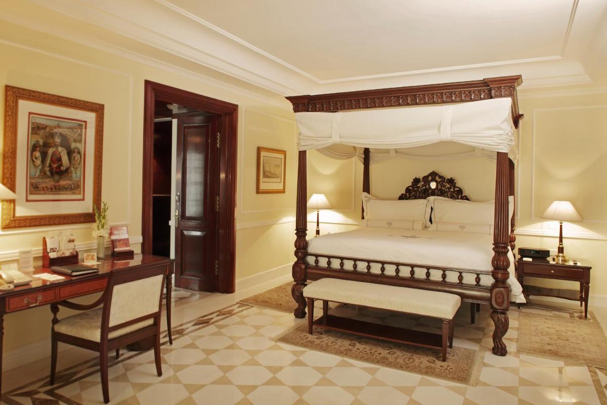 a bedroom with a canopy bed and a desk at The Imperial, New Delhi in New Delhi a bedroom with a canopy bed and a desk at The Imperial, New Delhi in New Delhi