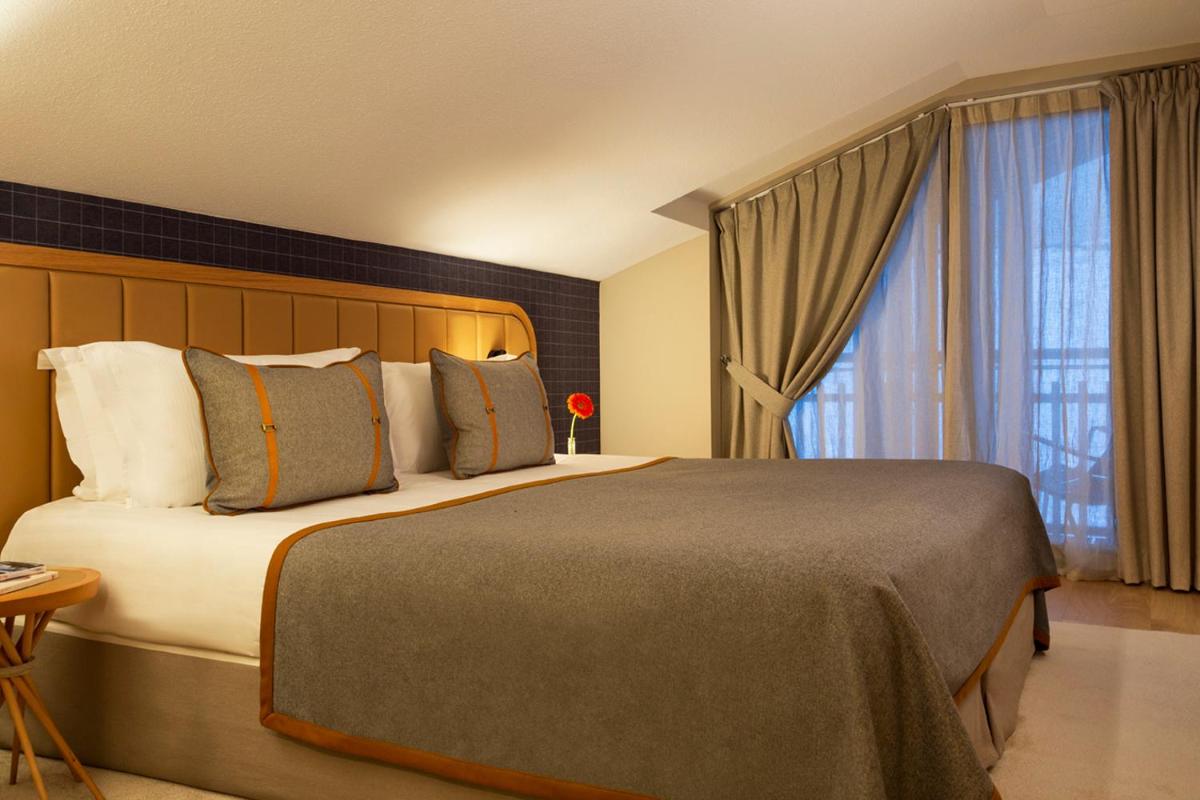 Un ou plusieurs lits dans un hébergement de l'établissement Heliopic Hotel & Spa