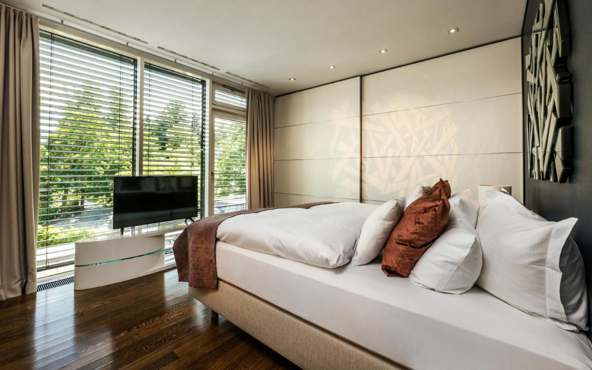Ein Bett oder Betten in einem Zimmer der Unterkunft Maison Messmer - ein Mitglied der Hommage Luxury Hotels Collection