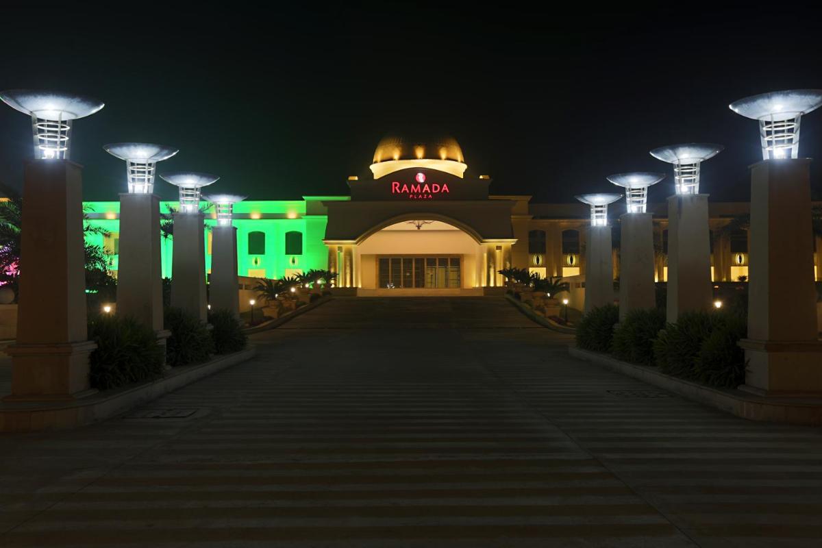 a building with a sign that reads raidani at night at Ramada Plaza by Wyndham Lucknow in Lucknow