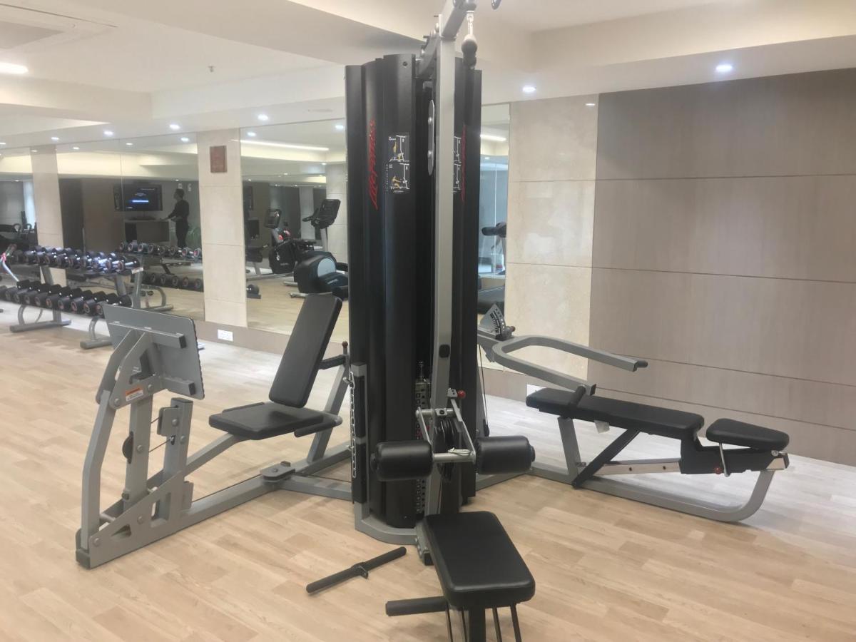 a gym with several tread machines in a room at Ramada Plaza by Wyndham Lucknow in Lucknow